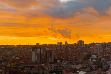 Fototapeta premium Peaceful sunset sky with clouds over the city of Istanbul, Turkey in the evening - apartment, residential buildings silhouettes. Architecture, urban, cityscape and summer concept