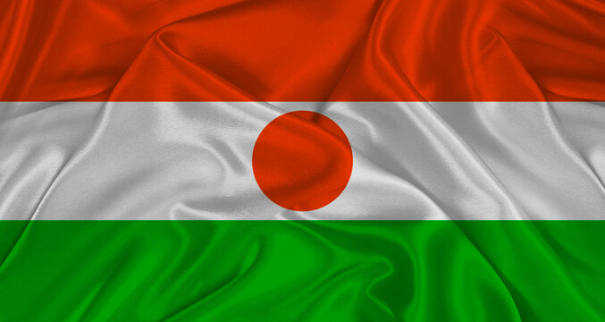 Nigerien flag with fabric texture. Realistic flag of Niger waving, National flag