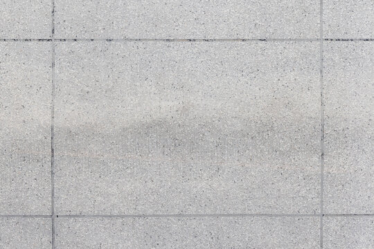 Rough gray wall made of concrete plates, front view, background photo texture