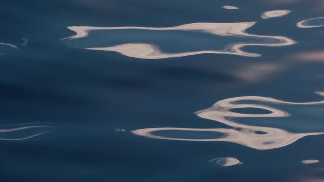 Sea surface with blinking stars and flares as seen from the moving sailing boat