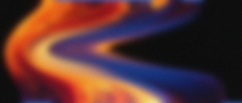 Hypnotic granular molten wax undulations display warm amber, fiery scarlet, and deep sapphire hues, evoking a classic lava lamp's internal glow.