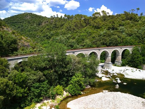 Aerial View of Historic Railway Bridge Crossing the Gardon River in Anduze, France