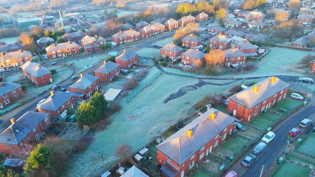 Drone's-eye winter view captures Dewsbury Moore Council estate's typical UK urban council-owned housing development with red-brick terraced homes and the industrial Yorkshire. Working class housing