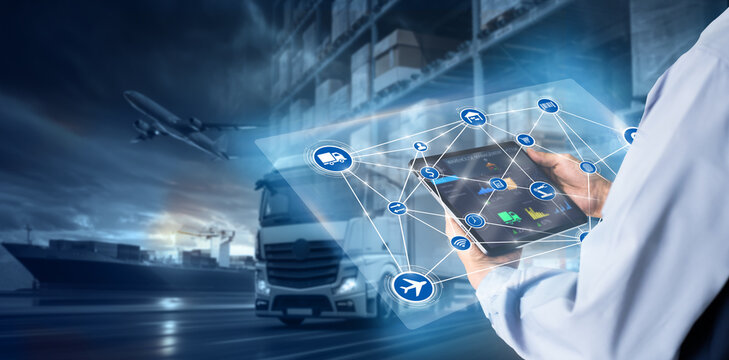 Smart Warehouse,Inventory management system concept.Manager using digital tablet,showing warehouse software management dashboard on blurred warehouse as background