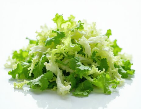 Pile of fresh shredded lettuce mix. Green and white leafy vegetables ready for salad. Healthy food ingredient on white surface. Natural food prep.