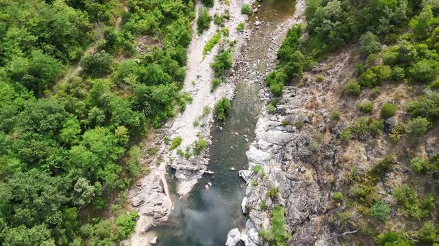 Scenic Rocky River Flowing Through the Lush Landscape of Anduze, France