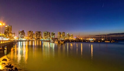 Fototapeta premium Nighttime Cityscape Reflection - A Stunning View of Urban Lights.