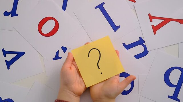 The child learns English letters. Selective focus.