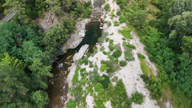Scenic Rocky River Flowing Through the Lush Landscape of Anduze, France