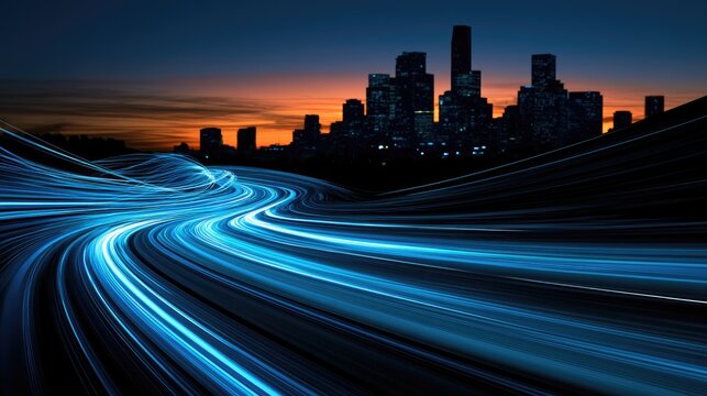Streaking blue lights trace a highway toward a silhouetted cityscape at dusk