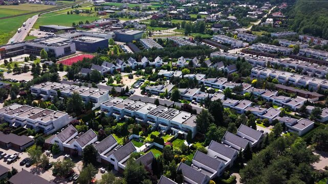 Aerial Drone View Suburban Housing District Modern Architecture Real Estate. Panoramic high angle shot of an upscale residential neighborhood featuring contemporary houses with solar panels