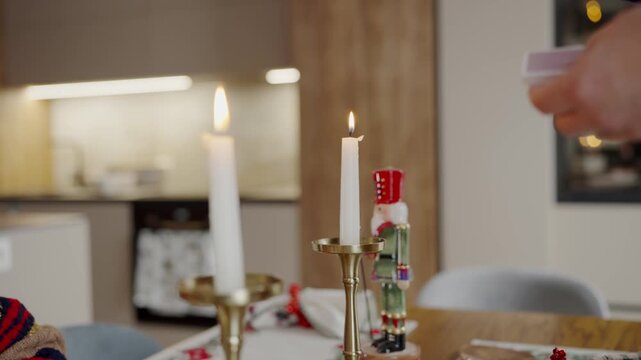 A warm, inviting scene at a Christmas dinner table featuring lit candles in golden holders and a colorful nutcracker decoration, creating a festive and cozy atmosphere. Cozy Christmas Dinner