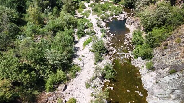 Scenic Rocky River Flowing Through the Lush Landscape of Anduze, France
