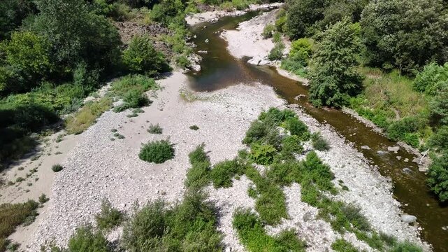 Scenic Rocky River Flowing Through the Lush Landscape of Anduze, France