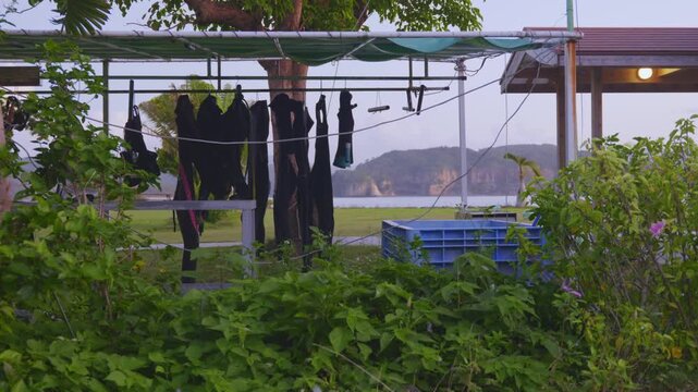 Scuba Diving Wetsuits Hanging to Dry at Sunset in Okinawa