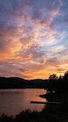 Fototapeta premium Dramatic sunset over a calm mountain lake