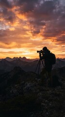 Fototapeta premium Photographer capturing sunset on mountain summit