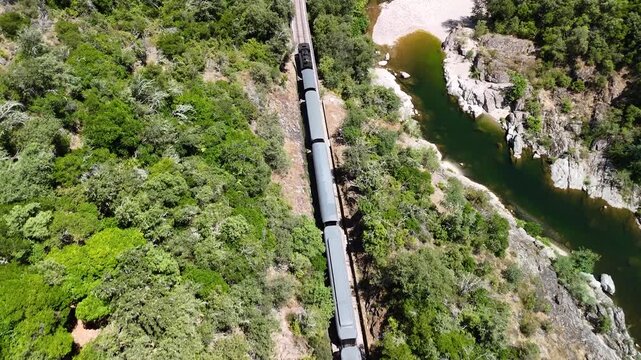 Aerial View of Historic Steam Train Crossing Stone Railway Viaduct near Anduze, France 