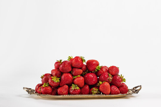 Ripe strawberries on a vintage tray on a white background. Vitamin C. Copy space. Isolated object