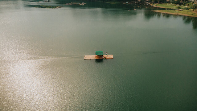 Aerial view of traditional bamboo raft on the calm water of Yambo Lake in Nagcarlan, Laguna, Philippines