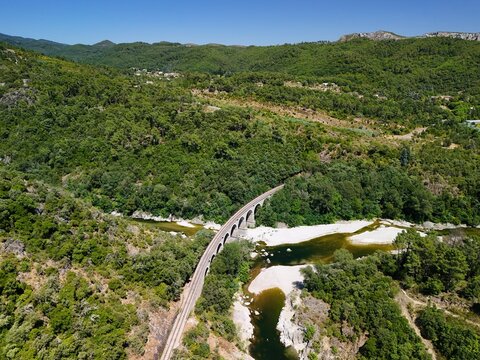 Aerial View of Historic Railway Bridge Crossing the Gardon River in Anduze, France