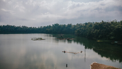 Tranquil aerial view of Yambo Lake with fish pens and lush forest in Nagcarlan Laguna, Philippines © Gids Stories
