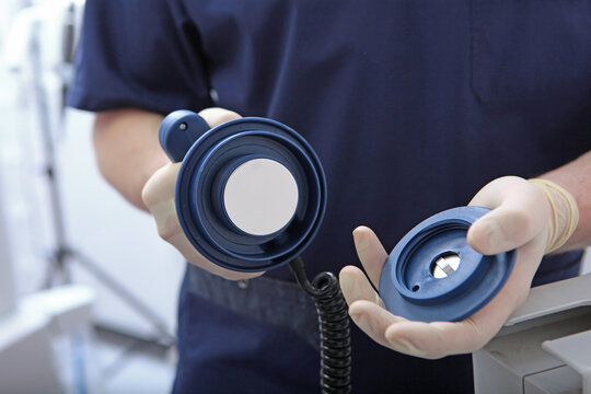 Discharge electrodes in hands of an intensive care doctor. Intensive care. Saving patient's life. Electropulse therapy of cardiac arrhythmias. Defibrillator is in hands of resuscitator