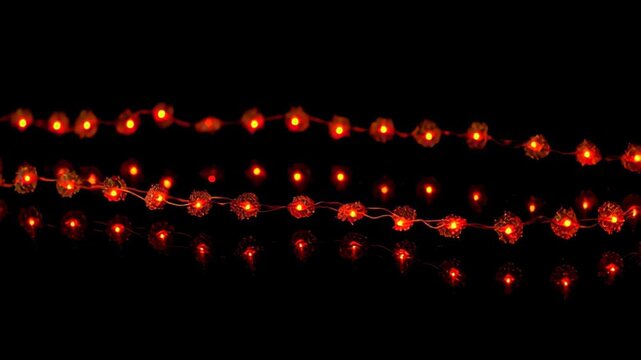 Warm red string lights glowing on black background festive decor, abstract motion background for modern creative design