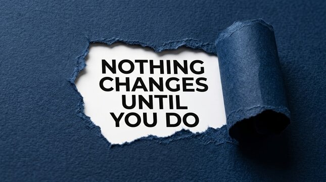 Inspiring nothing changes until you do text seen through ripped blue paper texture
