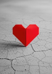 A bright red paper origami heart rests gently on a cold, cracked concrete floor, highlighting the contrast between fragile love and grit, folded, cracked, strength
