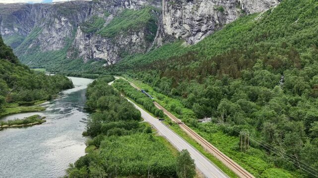 Aerial View of a Cargo Train Driving at the Foot of Trollstigen Mountains, Norway