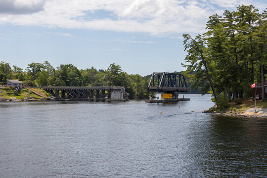 Scenic view of a historic bridge over a tranquil waterway in Parry Sound, Ontario.