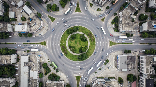 Aerial abstraction of a busy urban roundabout radiating traffic in every direction