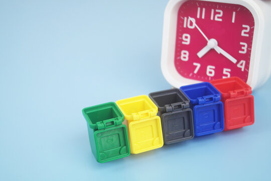 Trash cans and clock on blue background. Сleaning and garbage and trash concept.	
