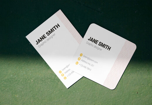Mockup of Two blank business cards are placed on a green surface
