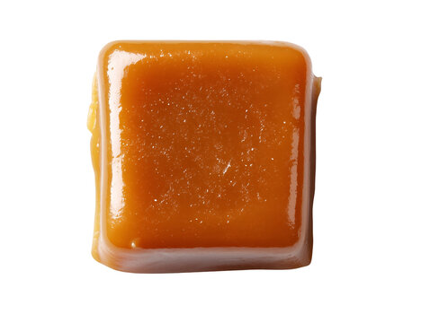 Single glossy caramel toffee square isolated on a white background with a smooth buttery texture and rich golden color.