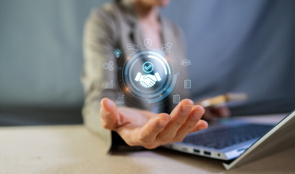 Business Partnership and Successful Deal Concept with Digital Handshake Virtual Icons on Laptop