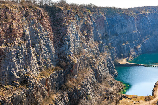 Majestic rocky cliffs overlooking pristine blue lake on sunny day