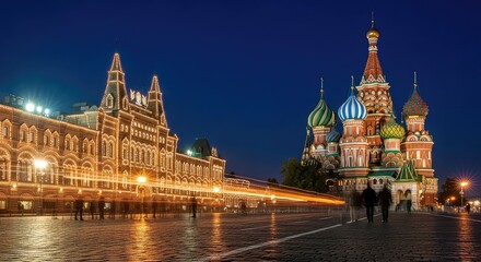 Obraz premium Illuminated historic cathedral and building at night in a city square setting