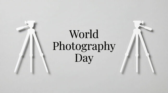 Two tripods flanking world photography day text in monochrome