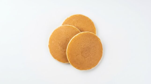 Three golden brown pancakes isolated on white background