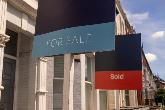 LONDON - for sale and sold estate agent signs on residential street