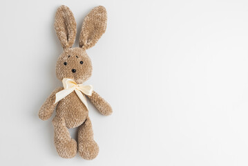 Fototapeta premium Handmade brown crochet plush bunny toy with ribbon