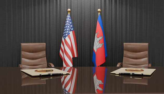 Diplomatic Meeting Room: Two chairs flank a polished table, adorned with the flags of the United States and Cambodia, set against a backdrop of elegant dark curtains.
