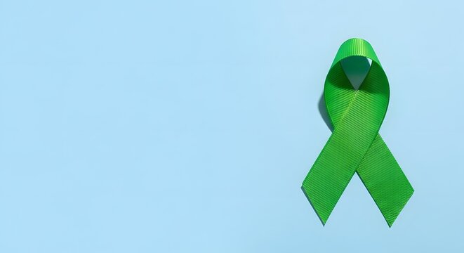 Green awareness ribbon on blue background. Mental health symbol. Medical support and care concept.