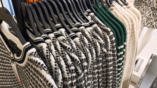 Assorted colorful clothes hanging neatly on a garment rack showcasing minimalist design and organized wardrobe display clean studio shot with bright soft even lighting for retail fashion boutique adve