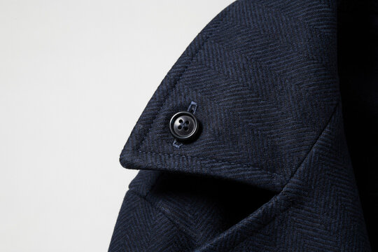Navy blue herringbone wool coat collar detail, elegant winter overcoat with button, luxury men's fashion outerwear texture on white background