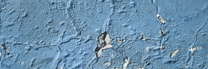 Blue painted concrete wall texture showing peeling paint and grunge background © Harry