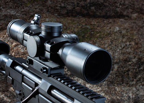Rain starting to drop on a rifle sight with a crosshair