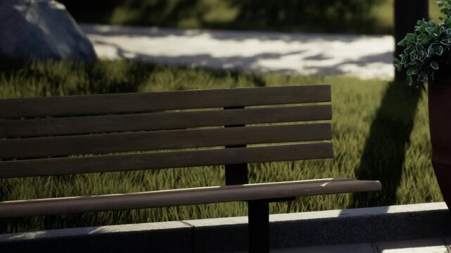 A wooden bench sits in a park space. Green grass grows around the bench. The sun shines bright above creating shadows on the ground. People walk in the distance.